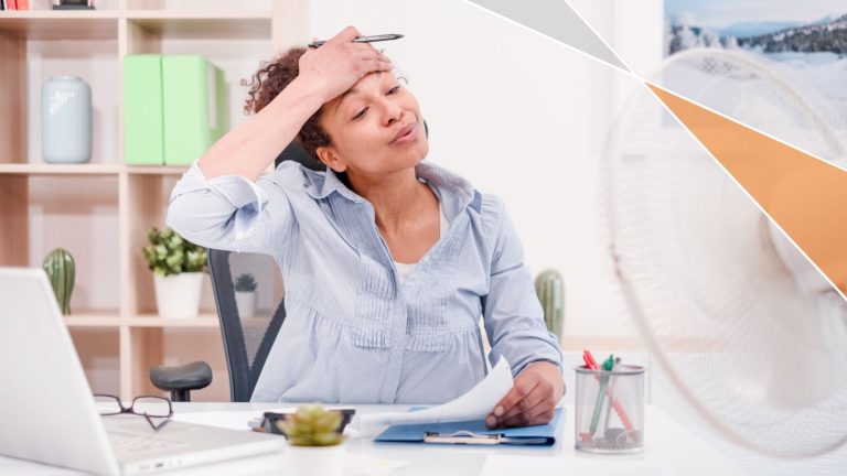 Keep Your Summer Marketing Campaigns Thriving_Lady at Desk Looking Hot in Front of Desk Fan
