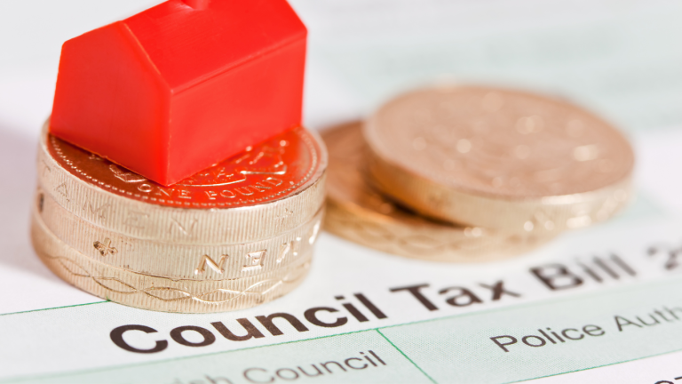 Local Government Mailing: Pound Coins on top of Council Tax Bil with Monopoly Red Hotel piece